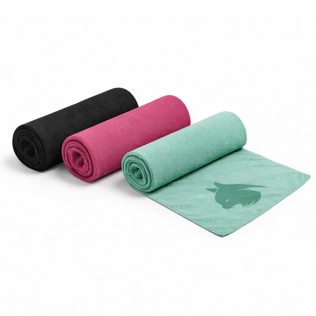 Three rolled-up towels in black, pink, and green on a white background