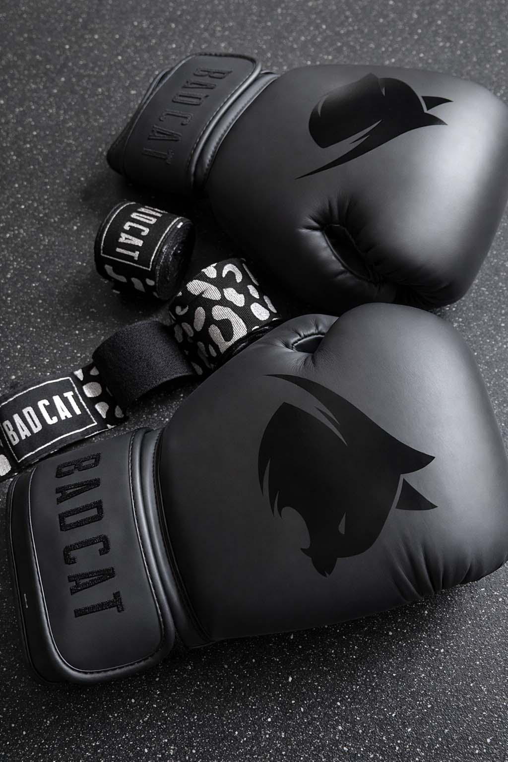 Black boxing gloves and leopard print hand wraps