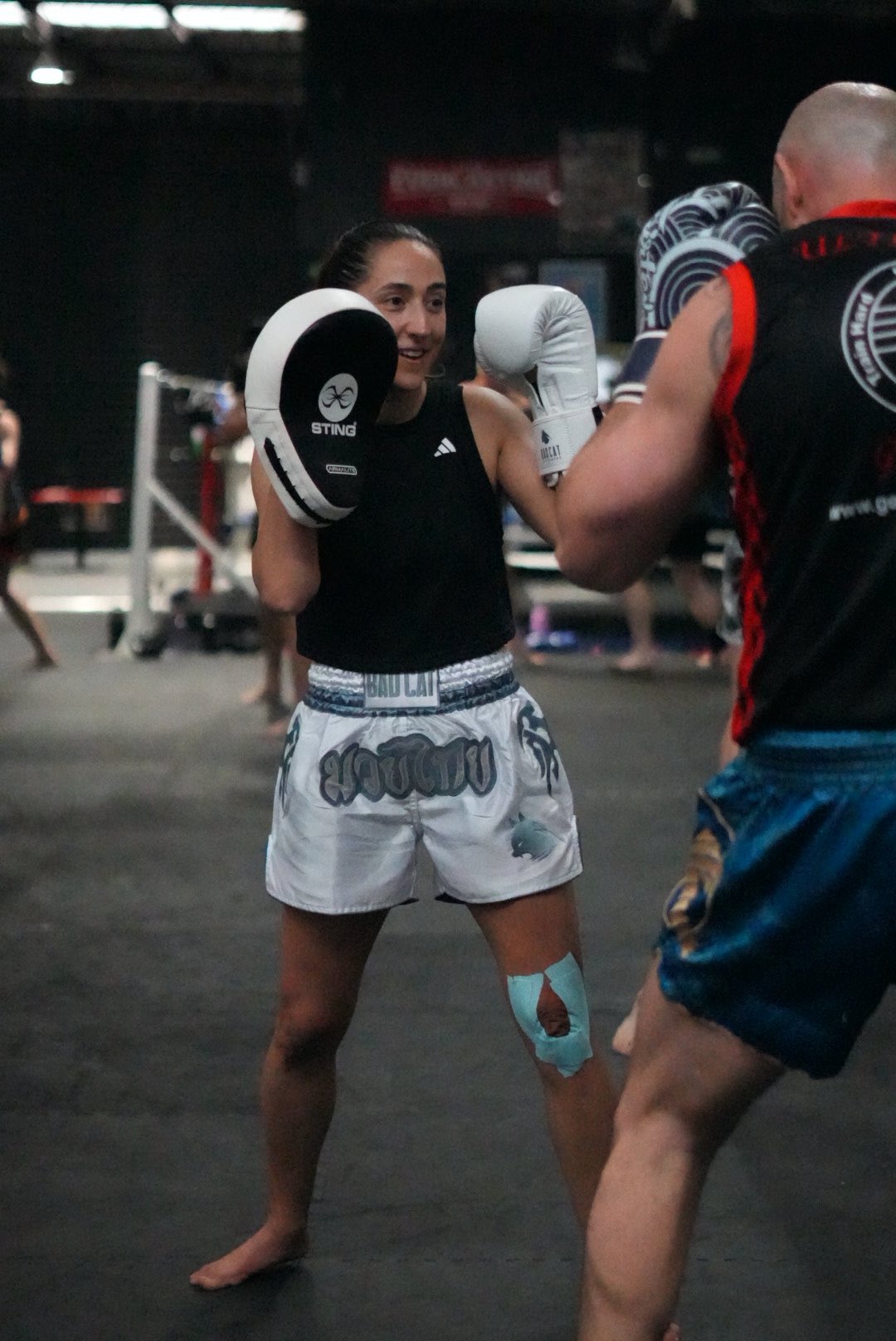 Two boxers in a training session with focus on technique and form.