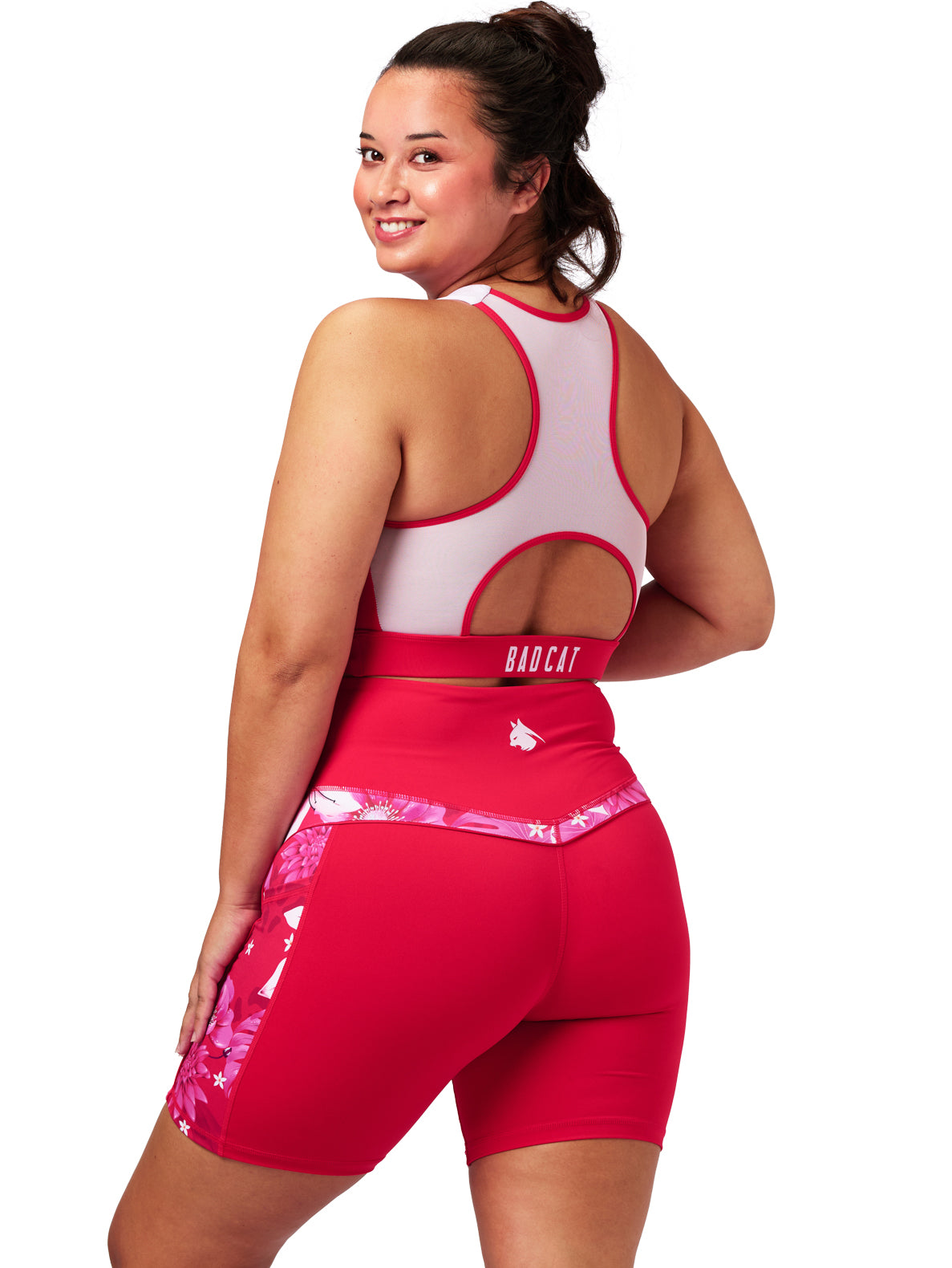 Woman wearing a red and white sports outfit with 'BAD CAT' branding on a white background