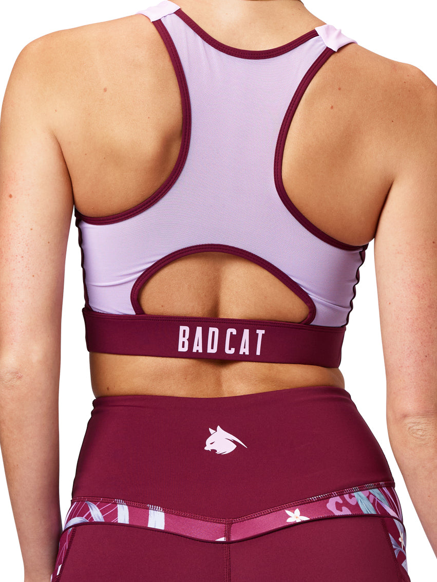 Maroon and white sports bra with 'BAD CAT' branding on a white background