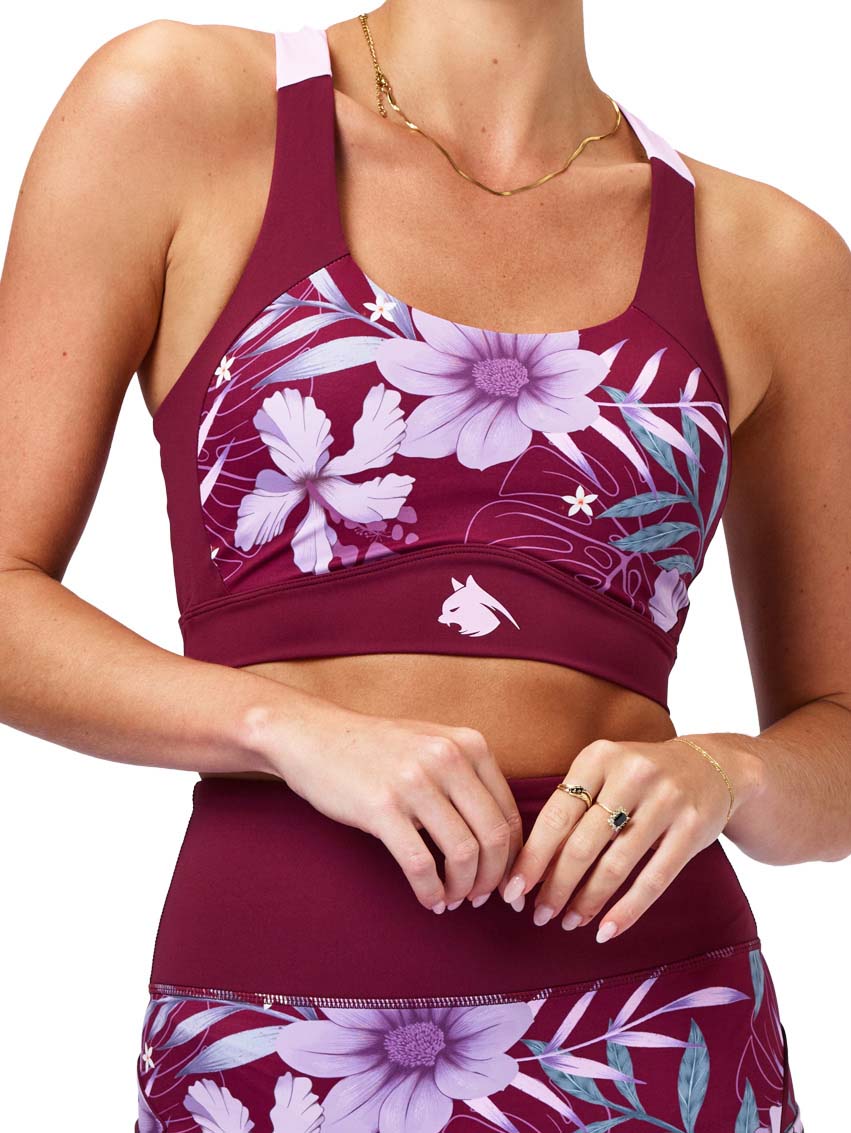 Maroon sports bra and shorts with floral design on a white background