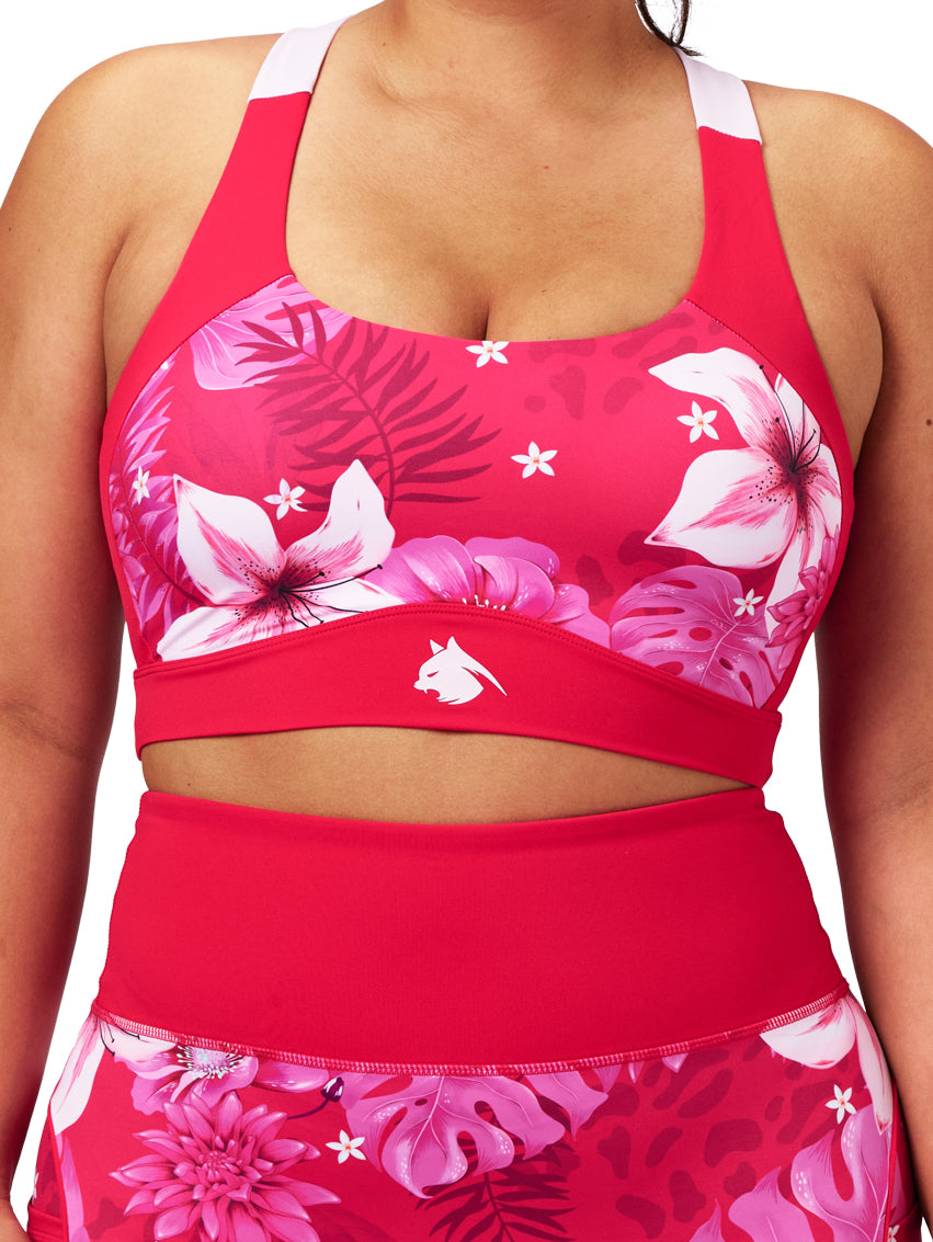 Red sports bra and shorts with floral pattern on a white background