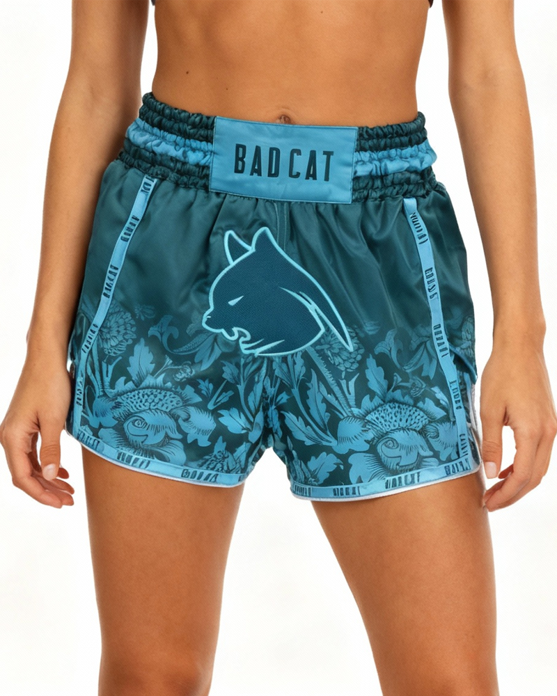 Teal shorts with a wolf logo and 'Bad Cat' text on a white background
