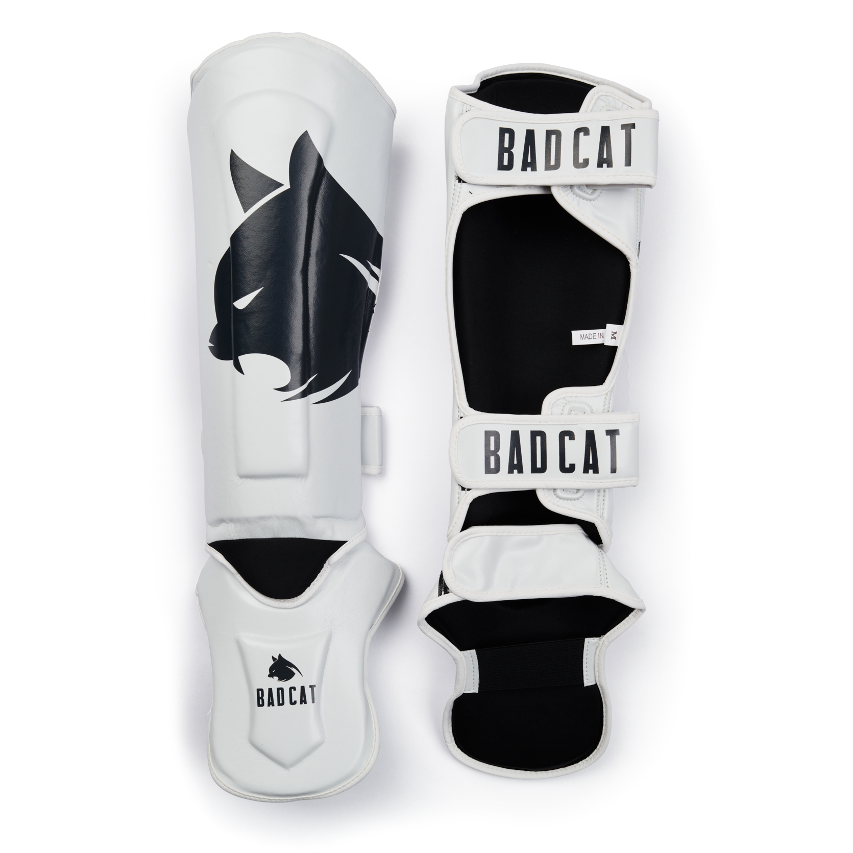 White shin guards with BAD CAT logo on a white background